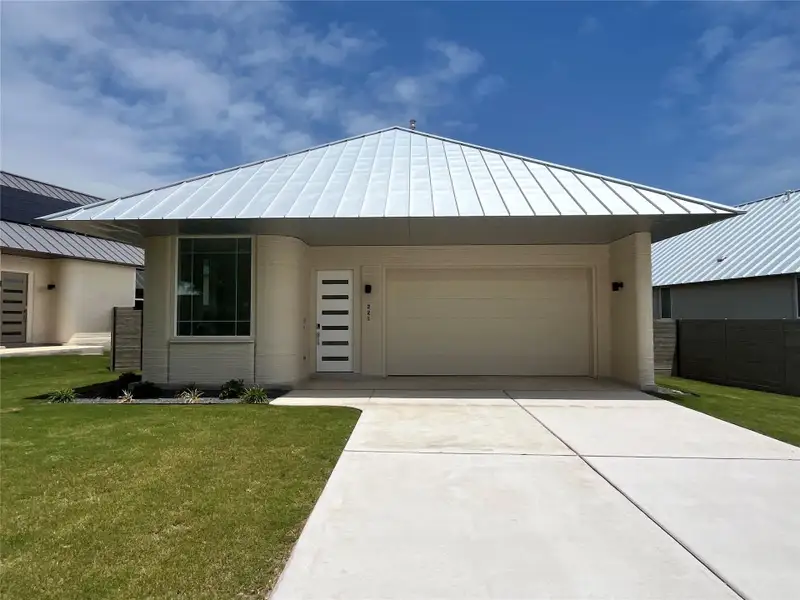 Front exterior of a new home in Wolf Ranch: Genesis Collection, Georgetown, TX, highlighting curb appeal (Image 1).