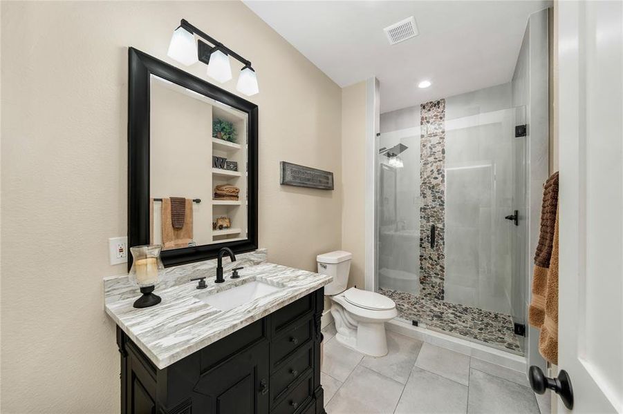 Full bathroom with vanity, light tile patterned floors, a stall shower, and recessed lighting