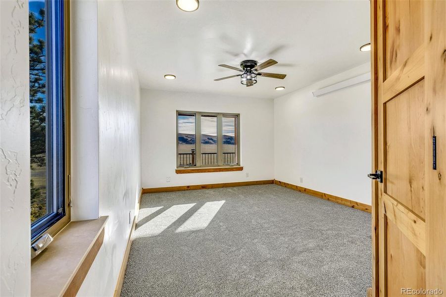 Looking at the main level primary bedroom from the primary bathroom.