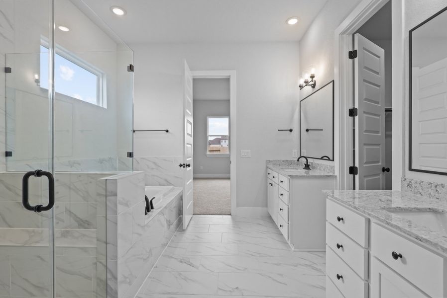 A bathroom with a glass shower. A bathroom with a glass shower.