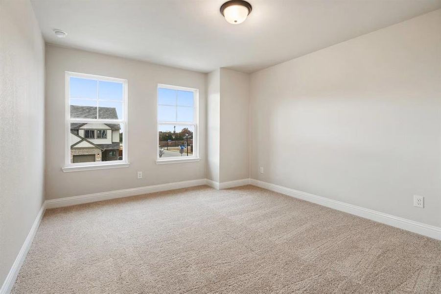 Unfurnished room with light colored carpet