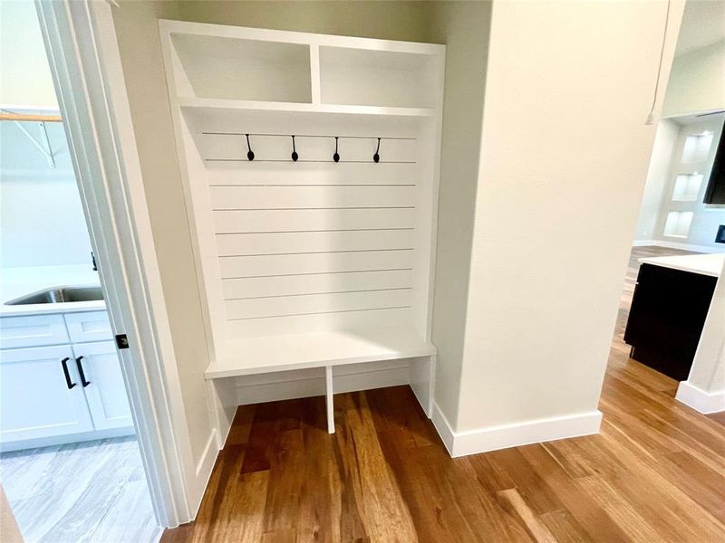 Mudroom with sink and light wood-type flooring