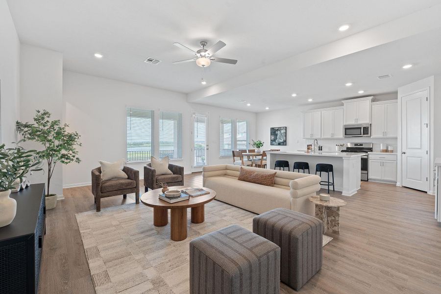 Living room with a ceiling fan, light wood finished floors, recessed lighting, and baseboards