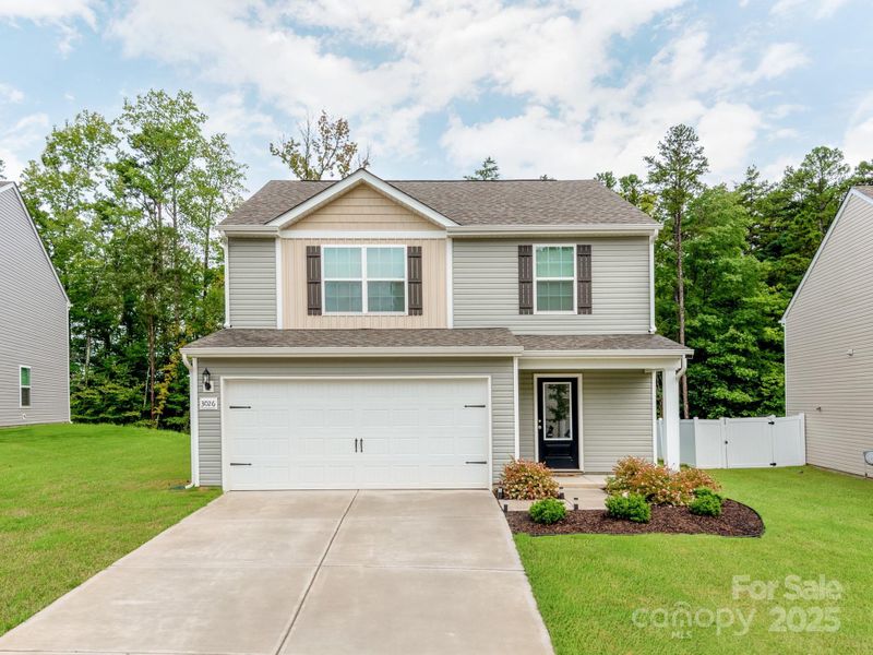 Front exterior of a new home in McKee Creek Village, Charlotte, NC, highlighting curb appeal (Image 19). Front exterior of a new home in McKee Creek Village, Charlotte, NC, highlighting curb appeal (Image 19).