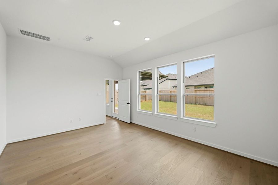 Cozy Main Bedroom With Hardwood Floors & Bright Windows Cozy Main Bedroom With Hardwood Floors & Bright Windows