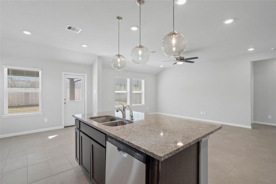 From the expansive kitchen island, enjoy seamless sightlines across the open-concept dining and living areas, making entertaining a breeze and ensuring you're never far from the conversation.