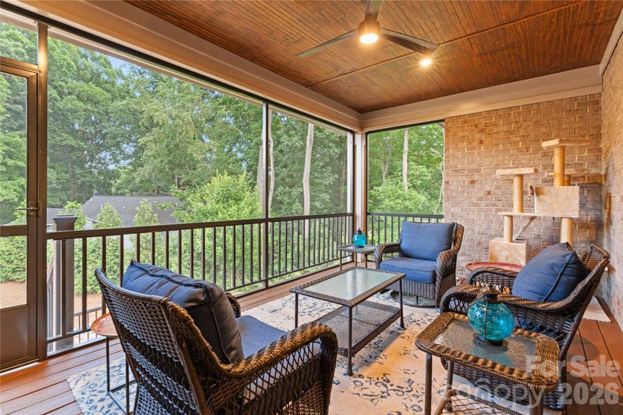 Lovely screened porch with composite, maintenance free decking material, attractive stained ceiling and view to common open space.