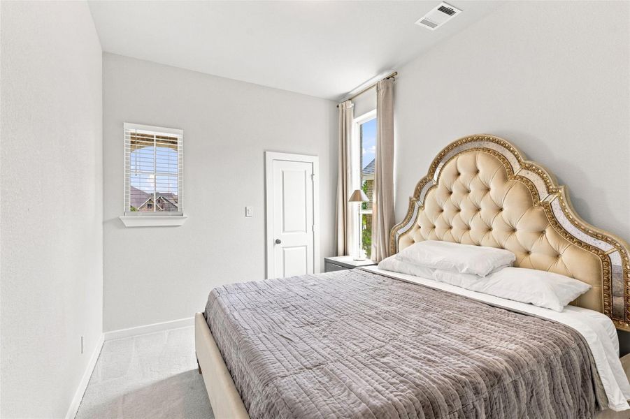 Additional En-suite bedroom with walk-in closet on first floor. King Bed shown here