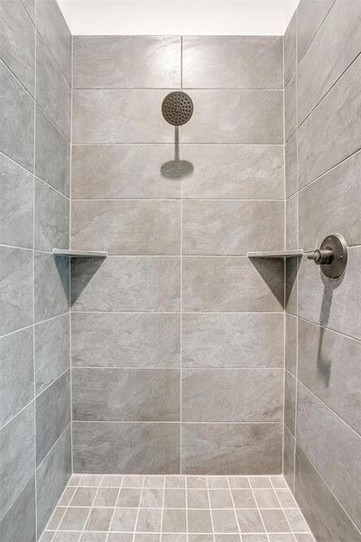 Bathroom featuring tiled shower