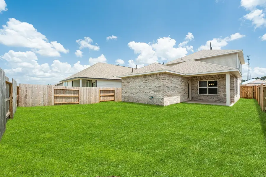 Front exterior of a new home in Stonebrooke, Conroe, TX, highlighting curb appeal (Image 16).