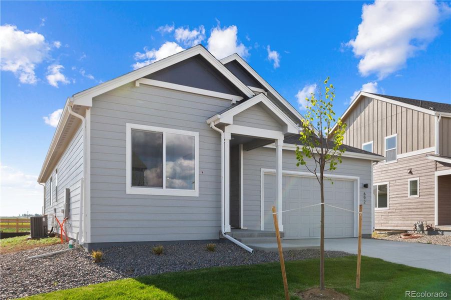Front exterior of a new home in Granary, Johnstown, CO, highlighting curb appeal (Image 19). Front exterior of a new home in Granary, Johnstown, CO, highlighting curb appeal (Image 19).