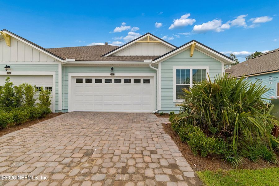 Front exterior of a new home in Westerly Park at Wildlight – Villa Collection, Yulee, FL, highlighting curb appeal (Image 1). Front exterior of a new home in Westerly Park at Wildlight – Villa Collection, Yulee, FL, highlighting curb appeal (Image 1).