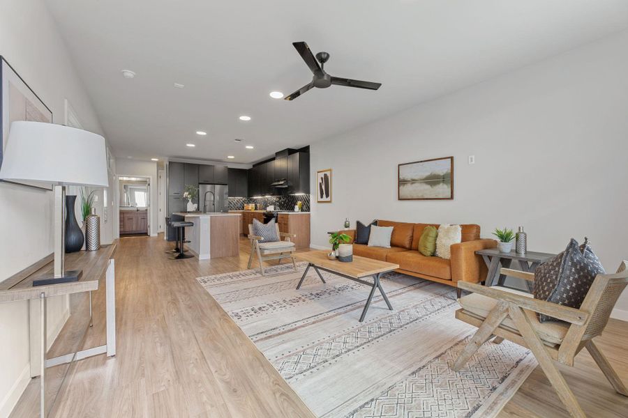 Living room featuring recessed lighting, a ceiling fan, and light wood finished floors
