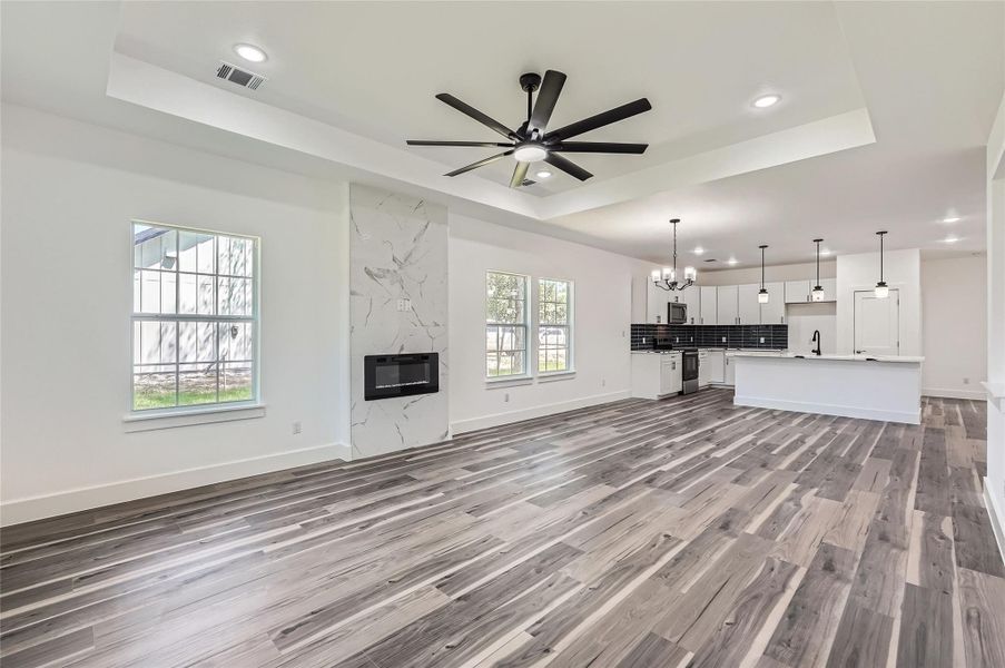 Living Room/Family Room featuring recessed lighting, ceiling fan and kitchen view