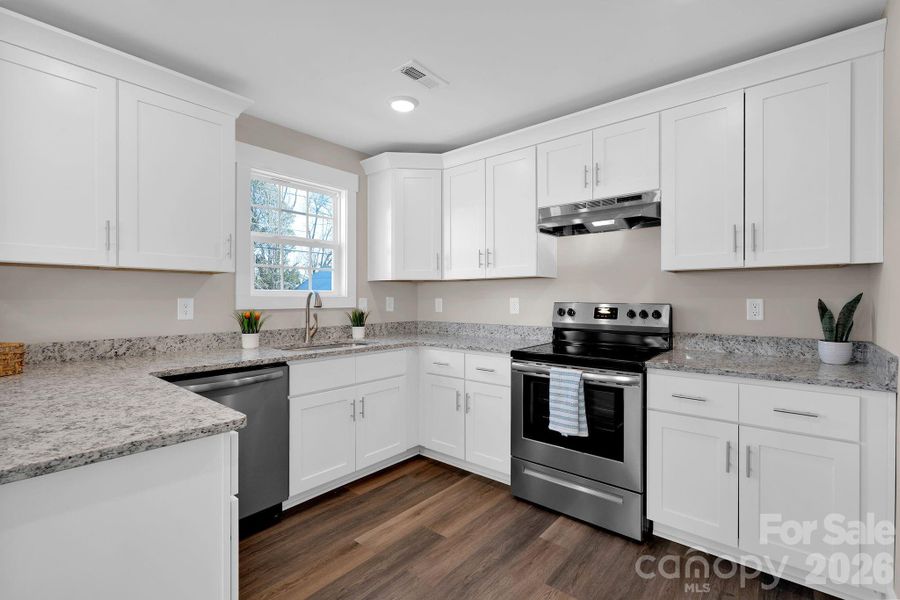 Bright kitchen with ample counter space and cabinetry.
