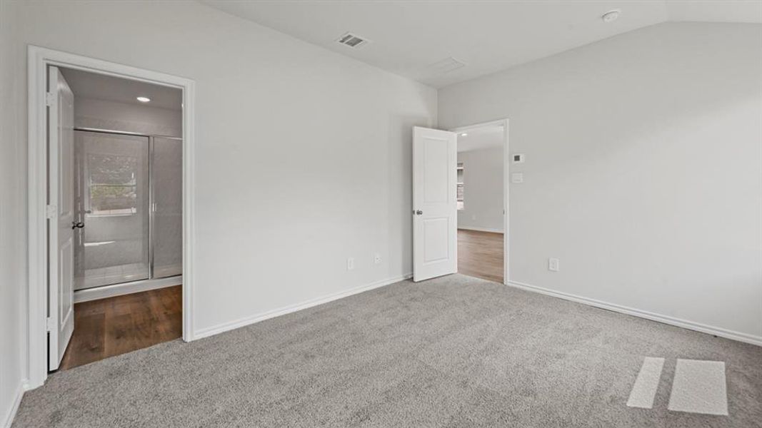 Spacious room featuring light gray carpeting and white painted walls