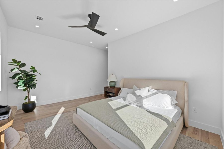 Bedroom featuring wood finished floors, recessed lighting, and ceiling fan Bedroom featuring wood finished floors, recessed lighting, and ceiling fan