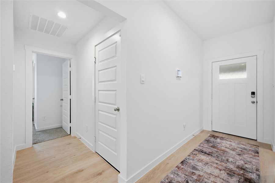 Plus...an additional bedroom and the entrance to the garage to the right.  The utility is also along this hallway.