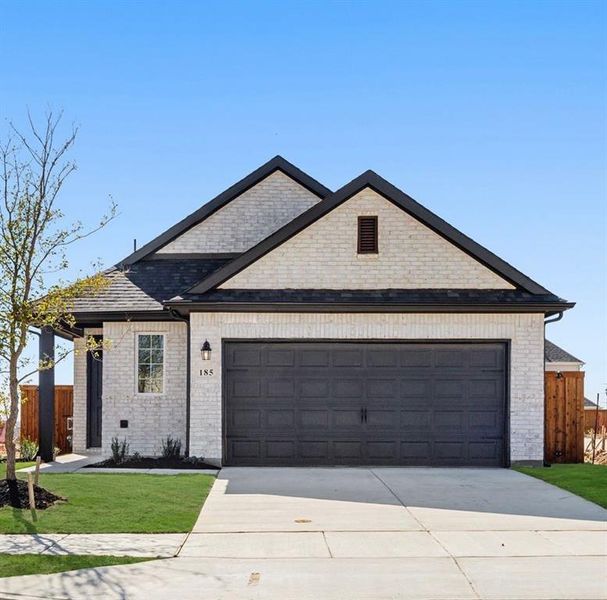 View of front facade featuring brick siding, concrete driveway, and a garage View of front facade featuring brick siding, concrete driveway, and a garage