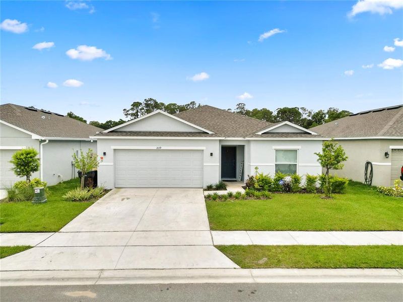 Front exterior of a new home in Ironwood, Lakeland, FL, highlighting curb appeal (Image 19).