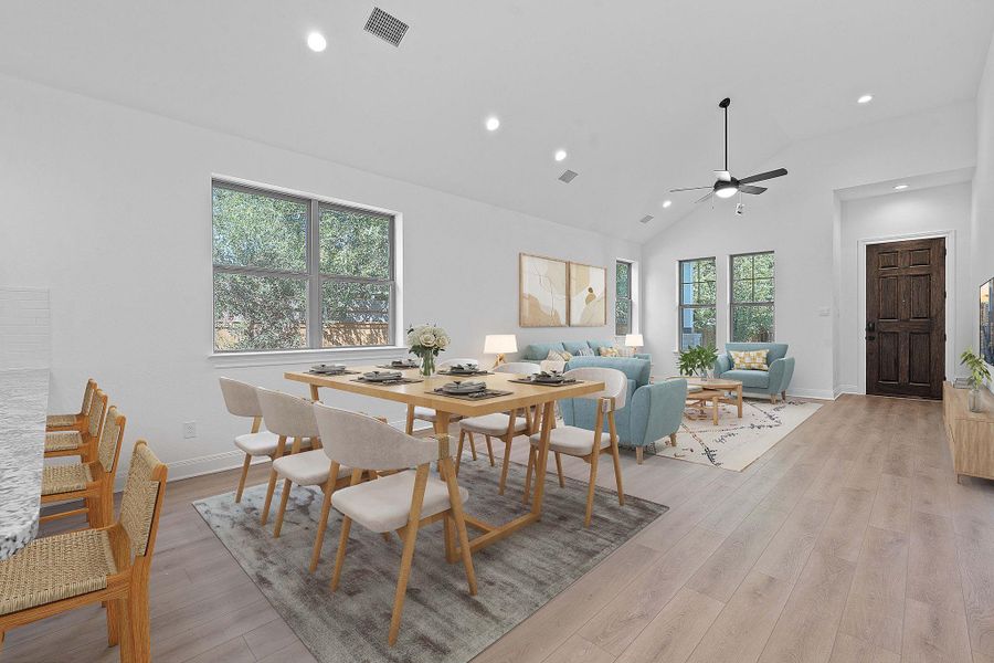 Dining area with light wood-style floors, recessed lighting, high vaulted ceiling, and a ceiling fan