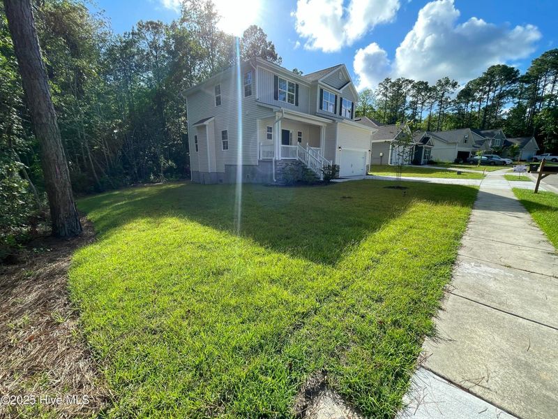 Front exterior of a new home in Mill Creek Cove, Bolivia, NC, highlighting curb appeal (Image 2).
