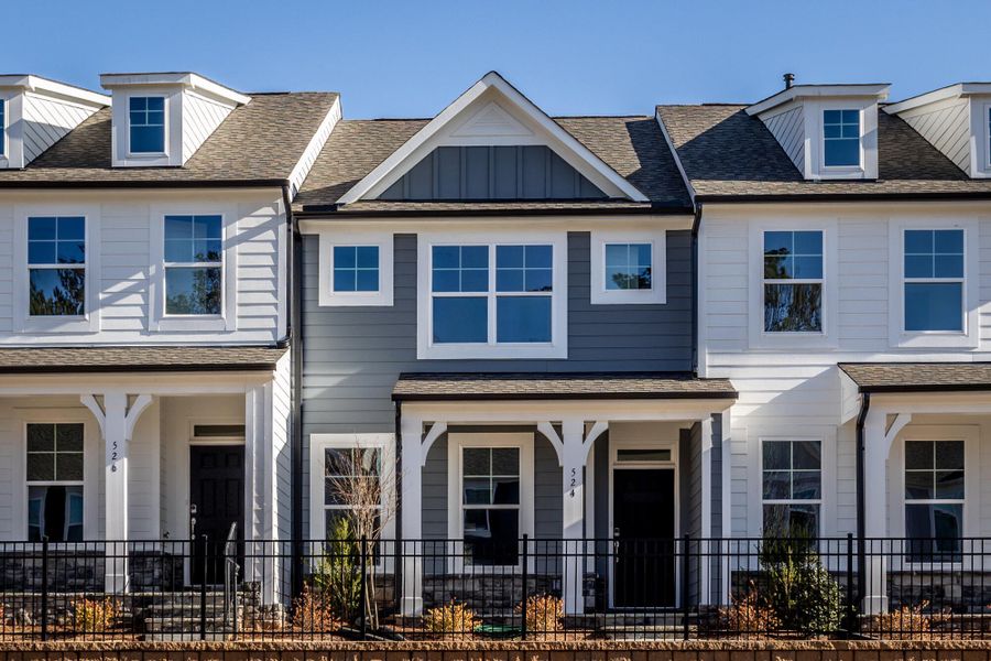 Front exterior of a new home in Enclave at Traditions Townhomes, Wake Forest, NC, highlighting curb appeal (Image 1). Front exterior of a new home in Enclave at Traditions Townhomes, Wake Forest, NC, highlighting curb appeal (Image 1).