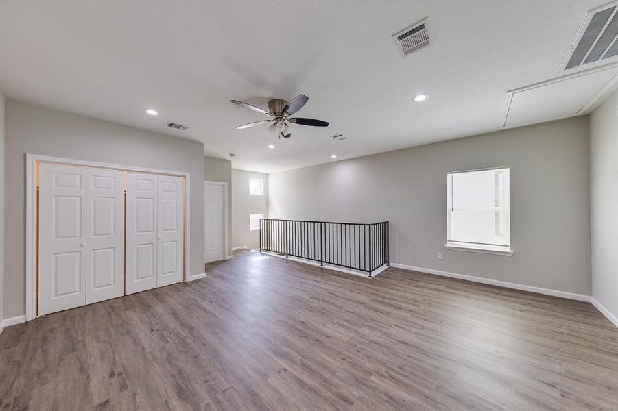 Every part of this home is designed with both style and comfort in mind, and the game room is no exception. The top-of-the-line laminate flooring is not only durable but also adds a touch of charm to the space. Large windows cover nearly every wall, filling the room with natural sunlight and creating a bright, inviting atmosphere. Whether it’s for relaxation or entertainment, this game room combines beauty and functionality to offer a perfect retreat for everyone.