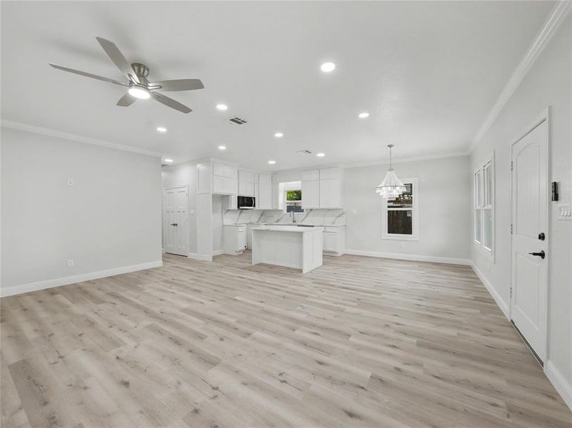Open-concept living space featuring wood-finish flooring, recessed lighting, and a contemporary ceiling fan