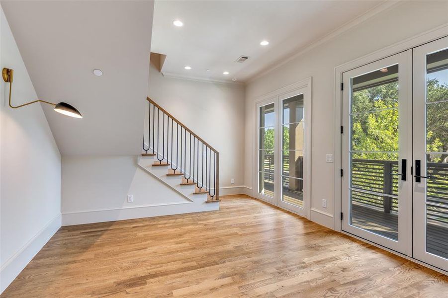 Doorway featuring recessed lighting, wood finished floors, stairway, crown molding, and french doors Doorway featuring recessed lighting, wood finished floors, stairway, crown molding, and french doors