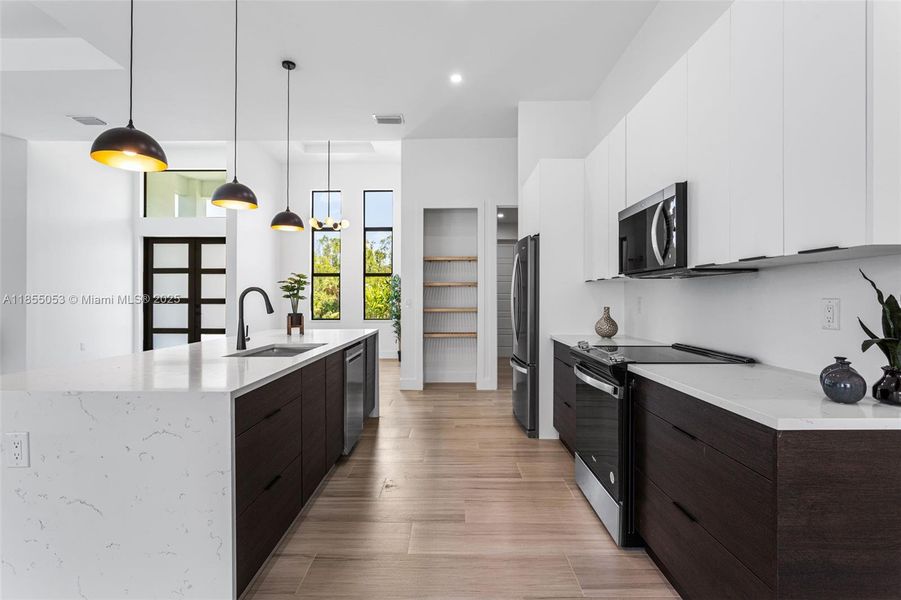 It features BLACK AND WHITE ITALIAN CABINETS & spacious QUARTZ WATERFALL ISLAND w/ BREAKSFAST BAR. It features BLACK AND WHITE ITALIAN CABINETS & spacious QUARTZ WATERFALL ISLAND w/ BREAKSFAST BAR.