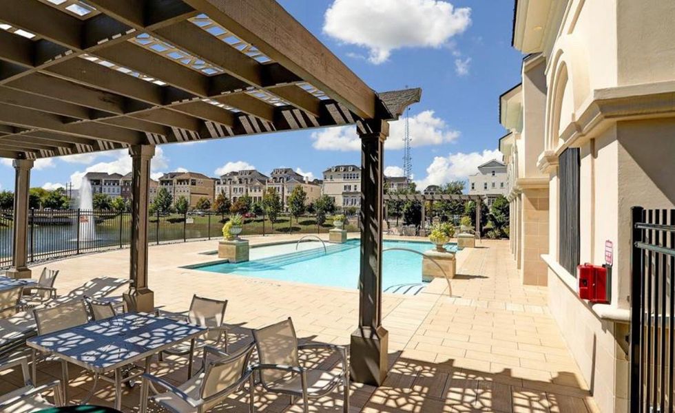 Enjoy a view of the stunning European-style pool from one of the community’s shaded seating areas.