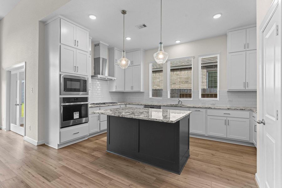 The Gourmet kitchen layout with built-in oven, gas cooktop, island seating, and a walk-in pantry for ample storage and more!  Notice all the cabinets for all your storage needs, simply amazing!