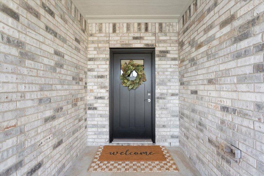 View of exterior entry with brick siding View of exterior entry with brick siding