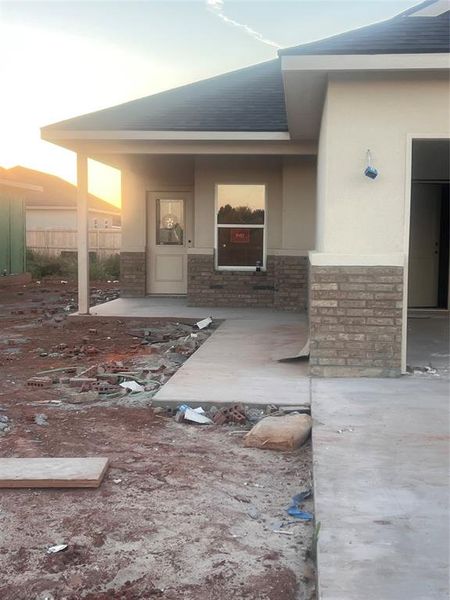 Doorway to property stucco siding and brick siding Doorway to property stucco siding and brick siding