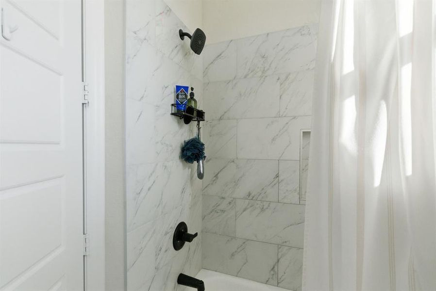 Bathroom featuring shower / bath combo with shower curtain