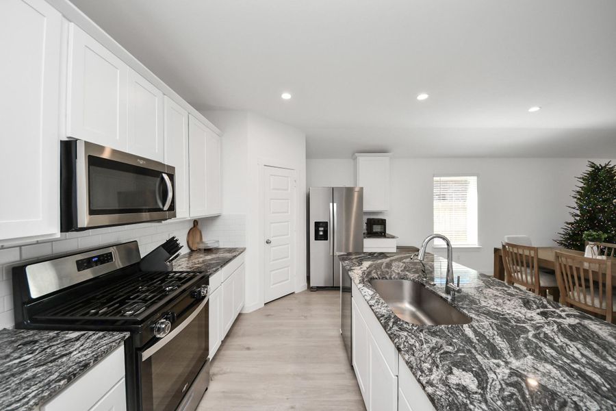 Stainless steel appliances along with these posh granite countertops really set the tone for the space.