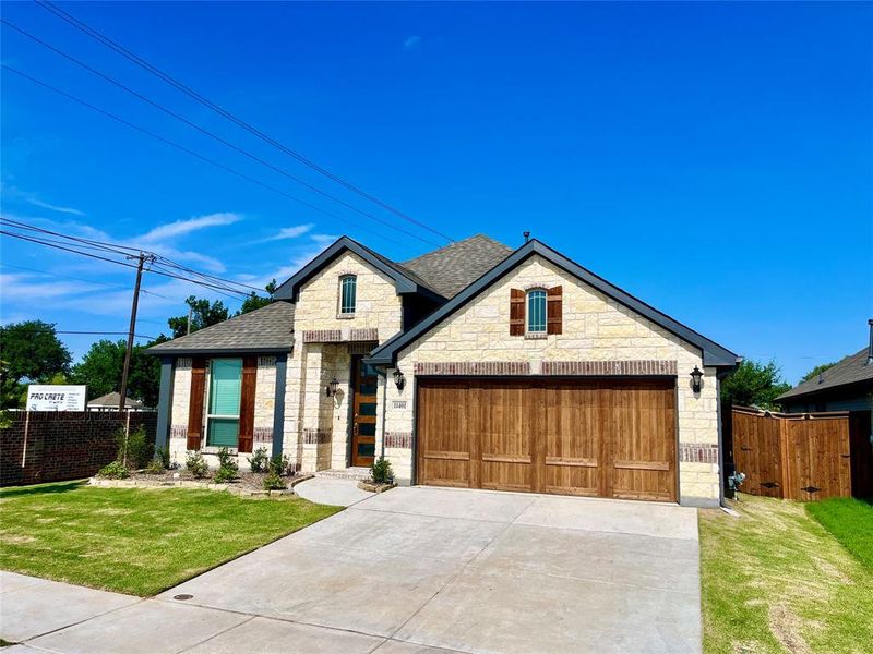 View of front of home with a front yard and a garage