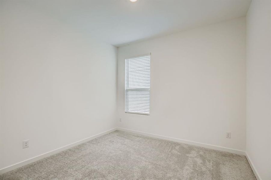 Spare room with carpet and baseboards
