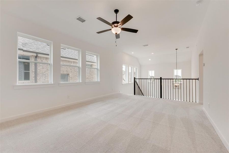 Unfurnished room with carpet, ceiling fan, recessed lighting, and vaulted ceiling Unfurnished room with carpet, ceiling fan, recessed lighting, and vaulted ceiling