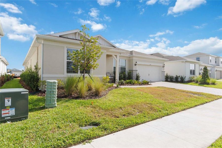 Front exterior of a new home in Bridgewalk, St. Cloud, FL, highlighting curb appeal (Image 23). Front exterior of a new home in Bridgewalk, St. Cloud, FL, highlighting curb appeal (Image 23).