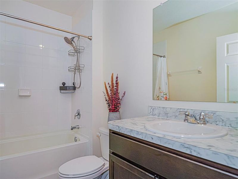 Guest full bath with title accent, new custom shower head and fixtures. Guest full bath with title accent, new custom shower head and fixtures.