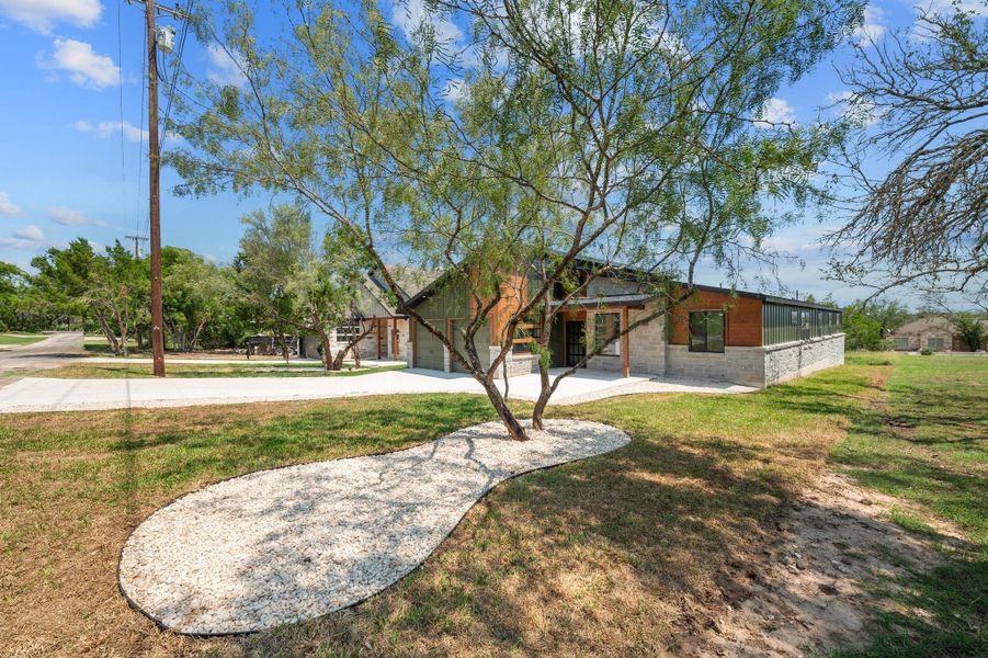 View of front of property featuring concrete driveway, a front lawn, and a garage View of front of property featuring concrete driveway, a front lawn, and a garage