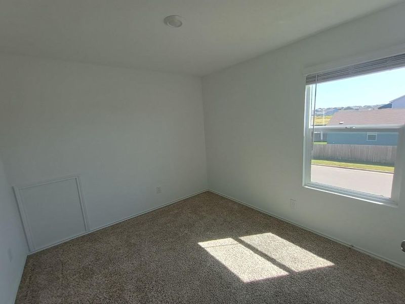 Unfurnished room with carpet flooring and baseboards Unfurnished room with carpet flooring and baseboards
