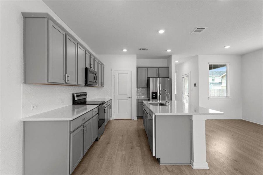Culinary delights await in this modern kitchen with ample counter space and an open design.