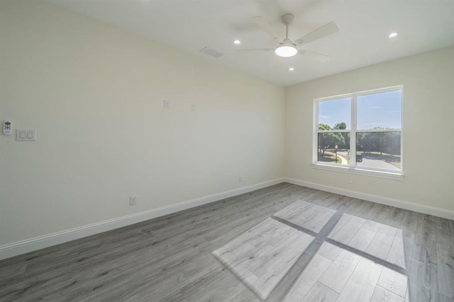 Spare room featuring recessed lighting, light wood-type flooring, and a ceiling fan Spare room featuring recessed lighting, light wood-type flooring, and a ceiling fan