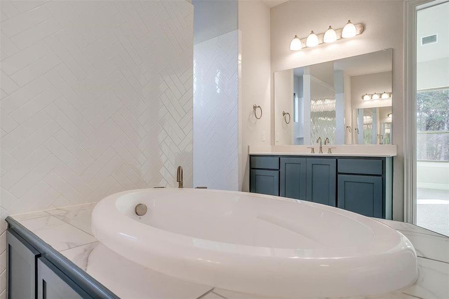 Bathroom with a bath and vanity