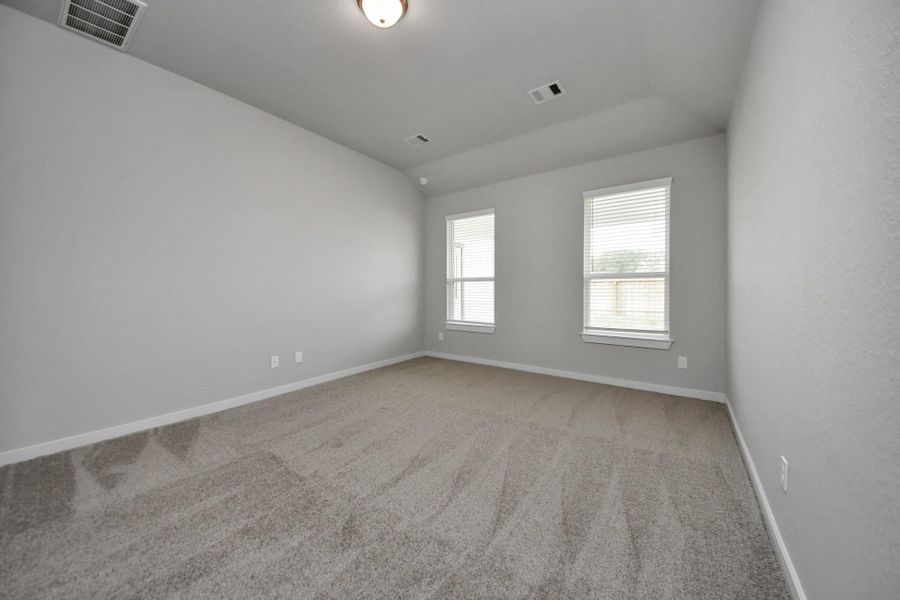 Escape and relax in the exquisite primary suite, a haven to unwind after a long day. Thespacious room, located on first floor, boasts plush carpeting, soothing paint tones, highceilings, and expansive windows adorned with privacy blinds. Sample photo of completed home with similar floor plan. Actual colors and selections may vary. Escape and relax in the exquisite primary suite, a haven to unwind after a long day. Thespacious room, located on first floor, boasts plush carpeting, soothing paint tones, highceilings, and expansive windows adorned with privacy blinds. Sample photo of completed home with similar floor plan. Actual colors and selections may vary.