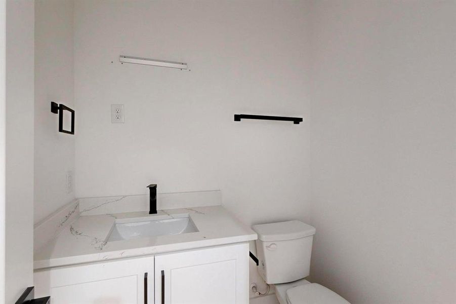 Bathroom with toilet and vanity Bathroom with toilet and vanity