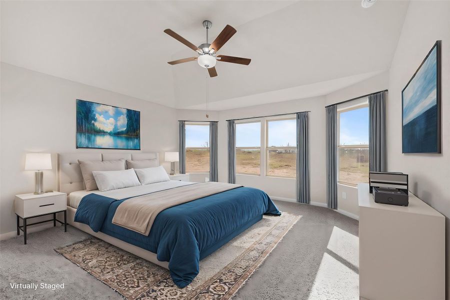 A well-lit bedroom features a vaulted ceiling and ample natural light from multiple windows.